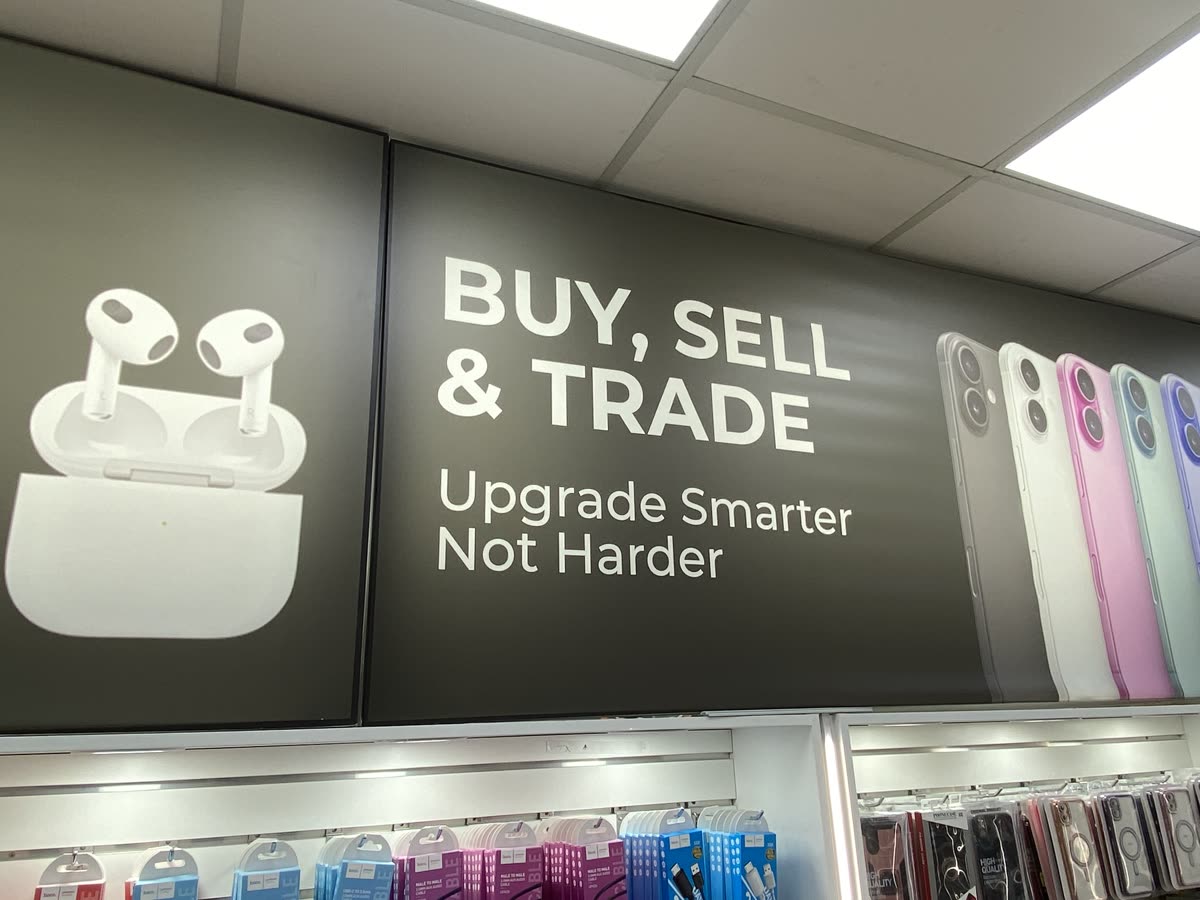 Buy, Sell and Trade — Upgrade Smarter Not Harder signage above the CellRox counter inside Walmart Ajax